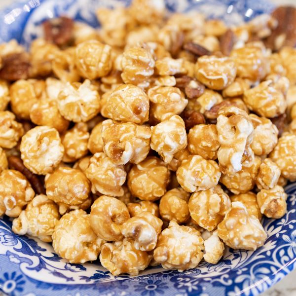 Ellis Bros Pecans caramel popcorn with pecan halves in blue and white bowl