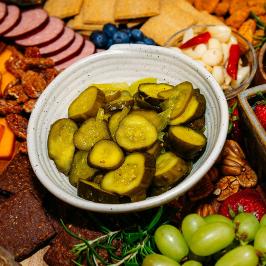 Bread & Butter Pickle slices in bowl on charcuterie board
