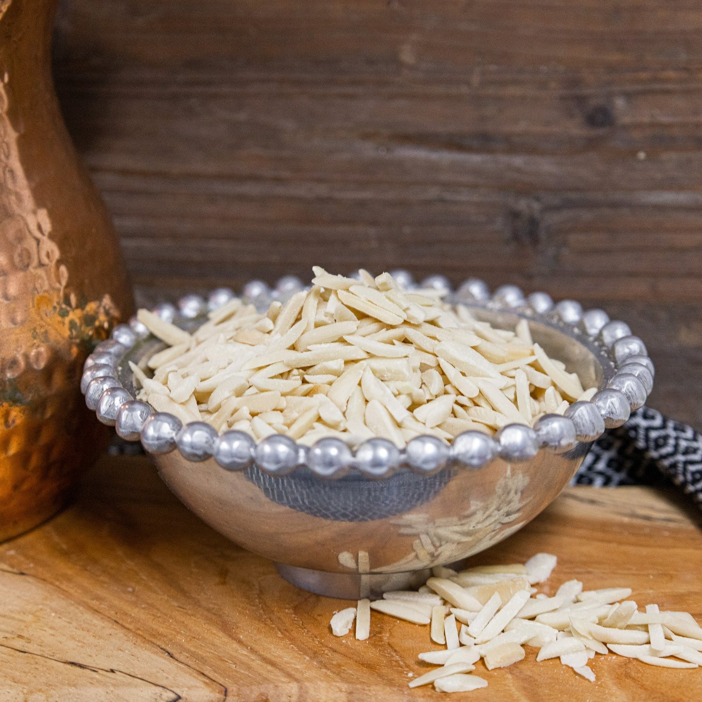 slivered raw almonds blanched in beaded pewter bowl