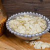 Thin sliced raw almonds in pewter beaded bowl