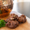 Ellis Bros Pecans milk chocolate peanut clusters on wooden board